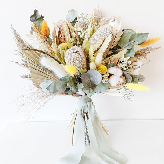 Australian native dried flower bridal bouquet with preserved banksia, eucalyptus, craspedia, and cotton – perfect for rustic or boho weddings.