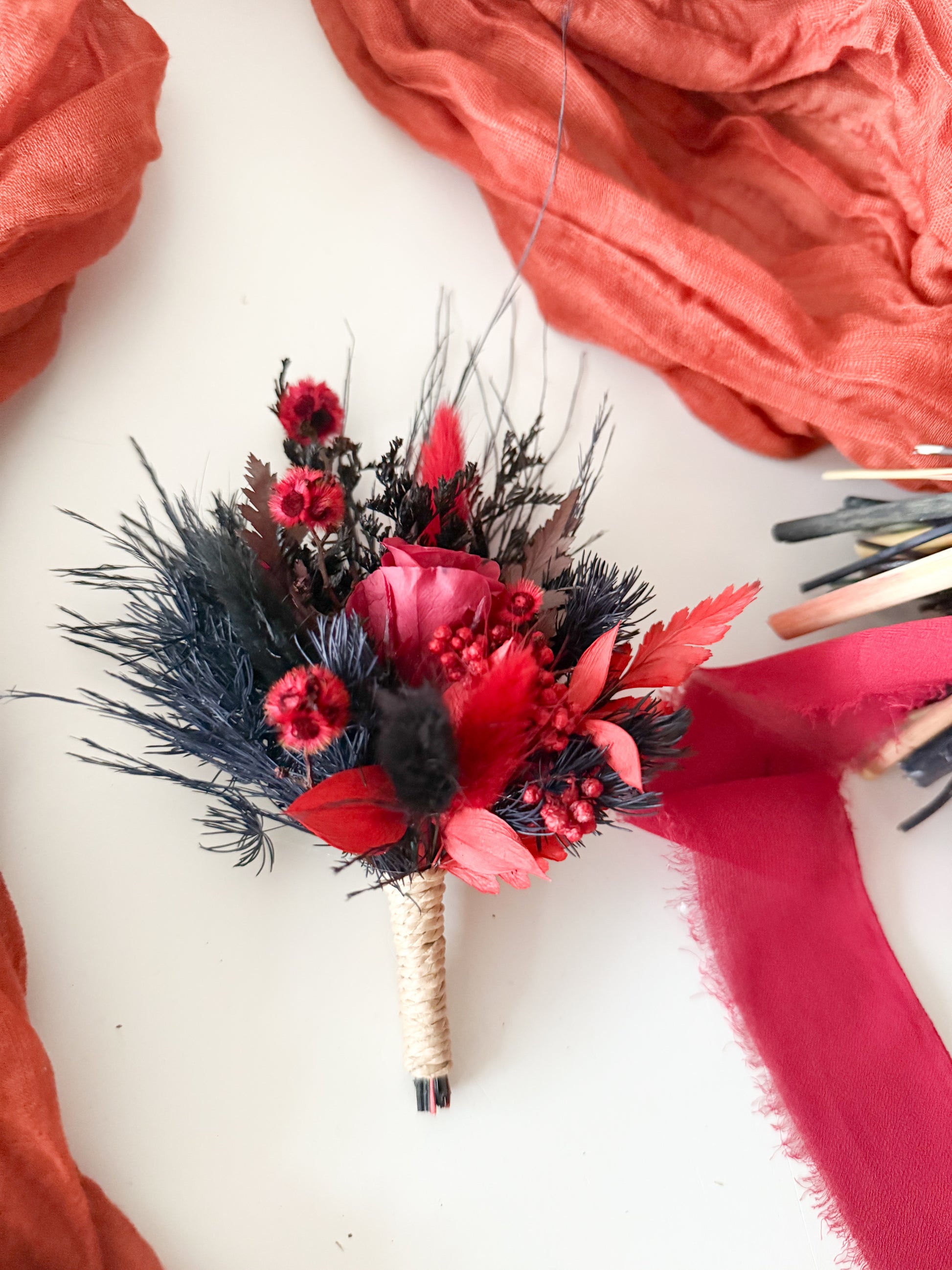 Bouquet with red and black flowers on a white background