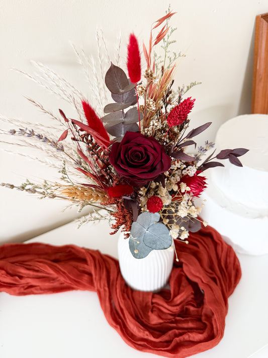 Burgundy dried flower arrangement in brown vase with preserved eucalyptus, banksia, and bunny tails – rustic boho wedding or home décor gift