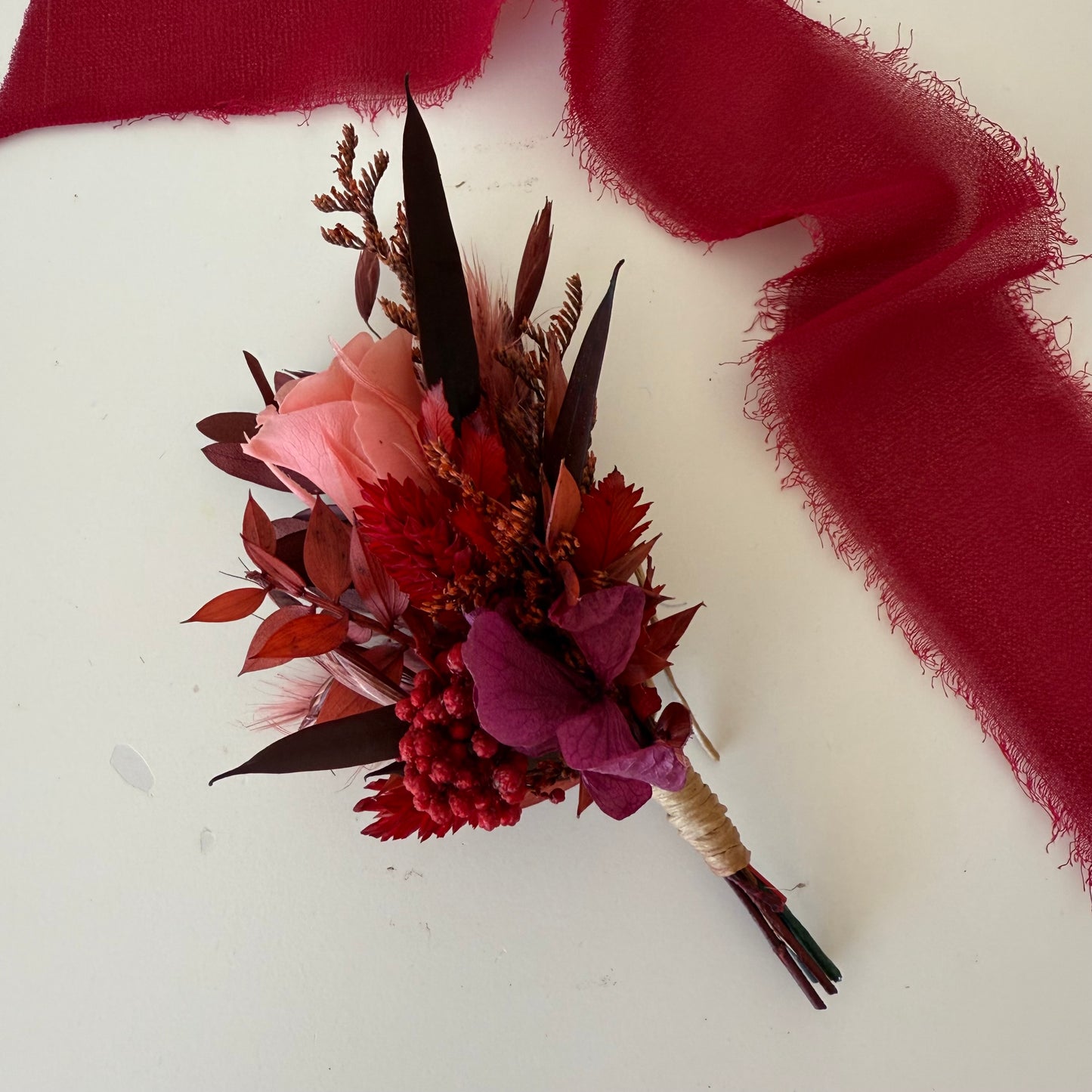 Burgundy groom wedding boutonniere