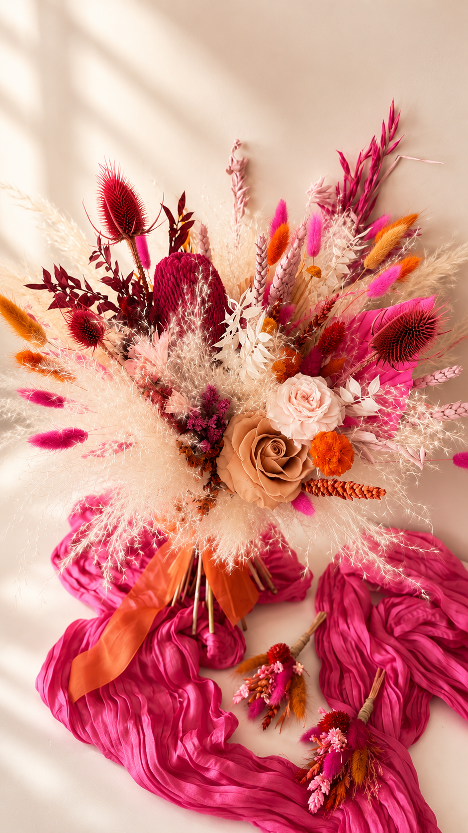 Colorful floral arrangement with pink, orange, and white flowers on a light background