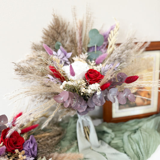 Bouquet of flowers with red roses and greenery on a white background