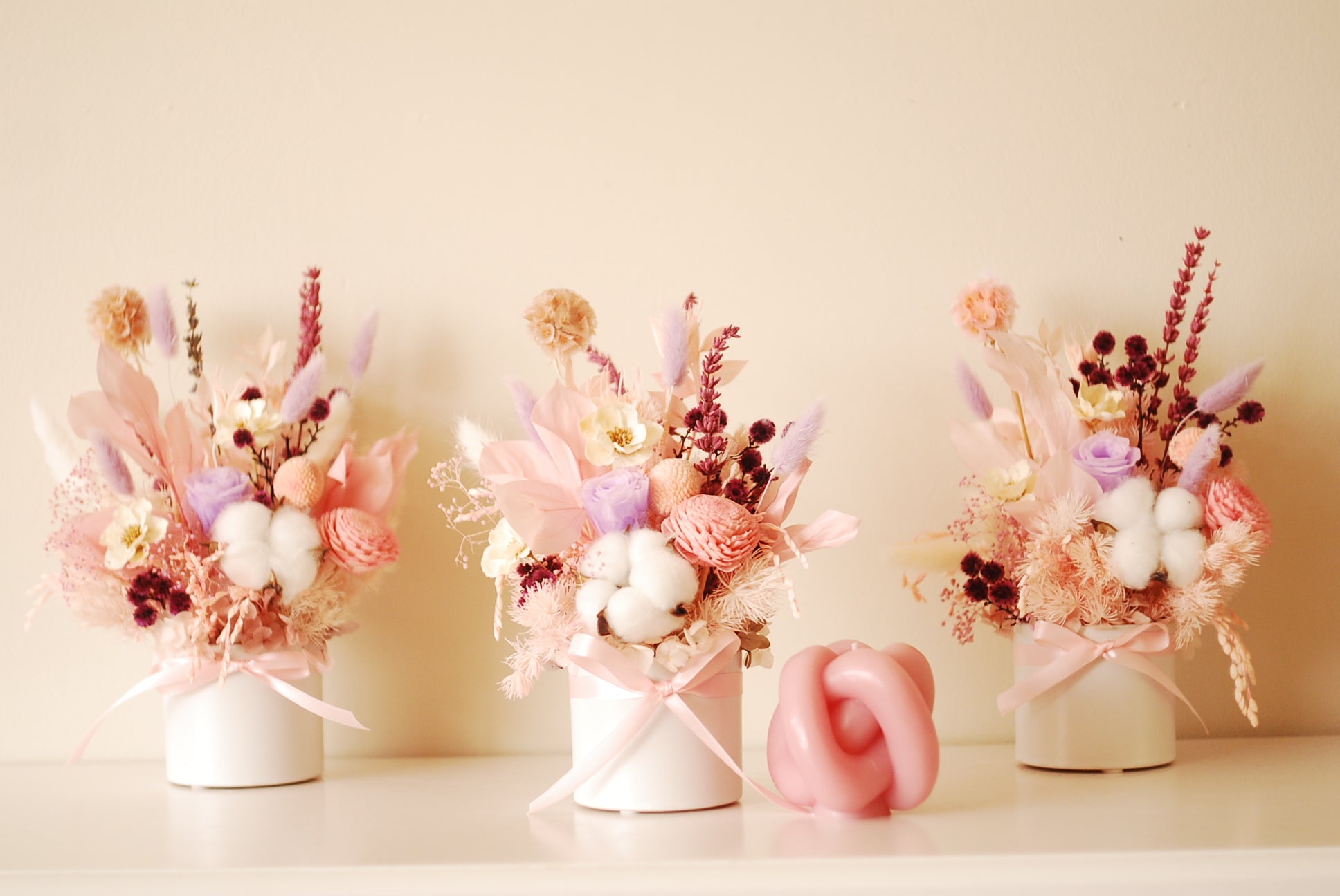 Dried flower gift box with pink and purple blooms, cotton accents, and a satin ribbon.