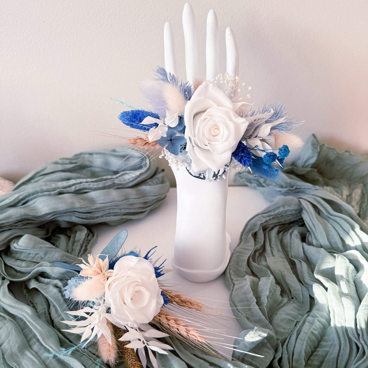 Floral boutonniere and corsage on a textured fabric background