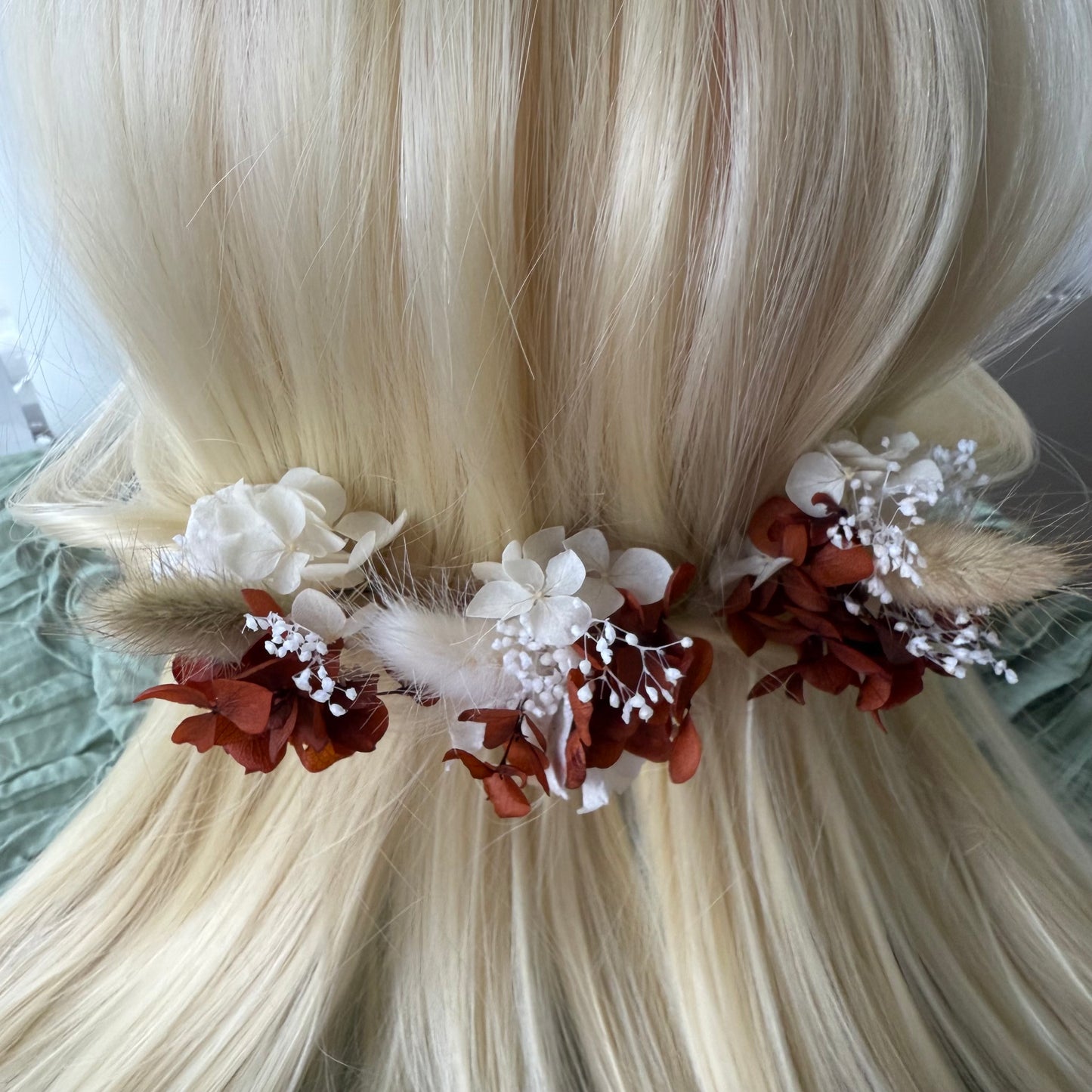 Floral hair accessory with white and brown flowers on blonde hair