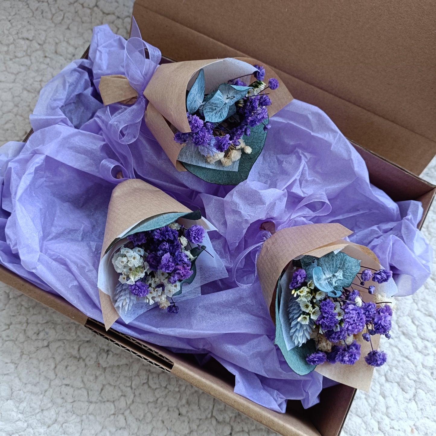 Handmade mini dried flower favours in lavender tones, tied with organza ribbon. Great for weddings in Sydney, Melbourne, Brisbane, and more.