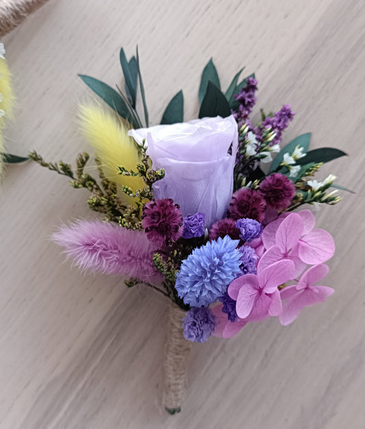 Lavender rose boutonniere with dried pink, blue and yellow florals for boho wedding
