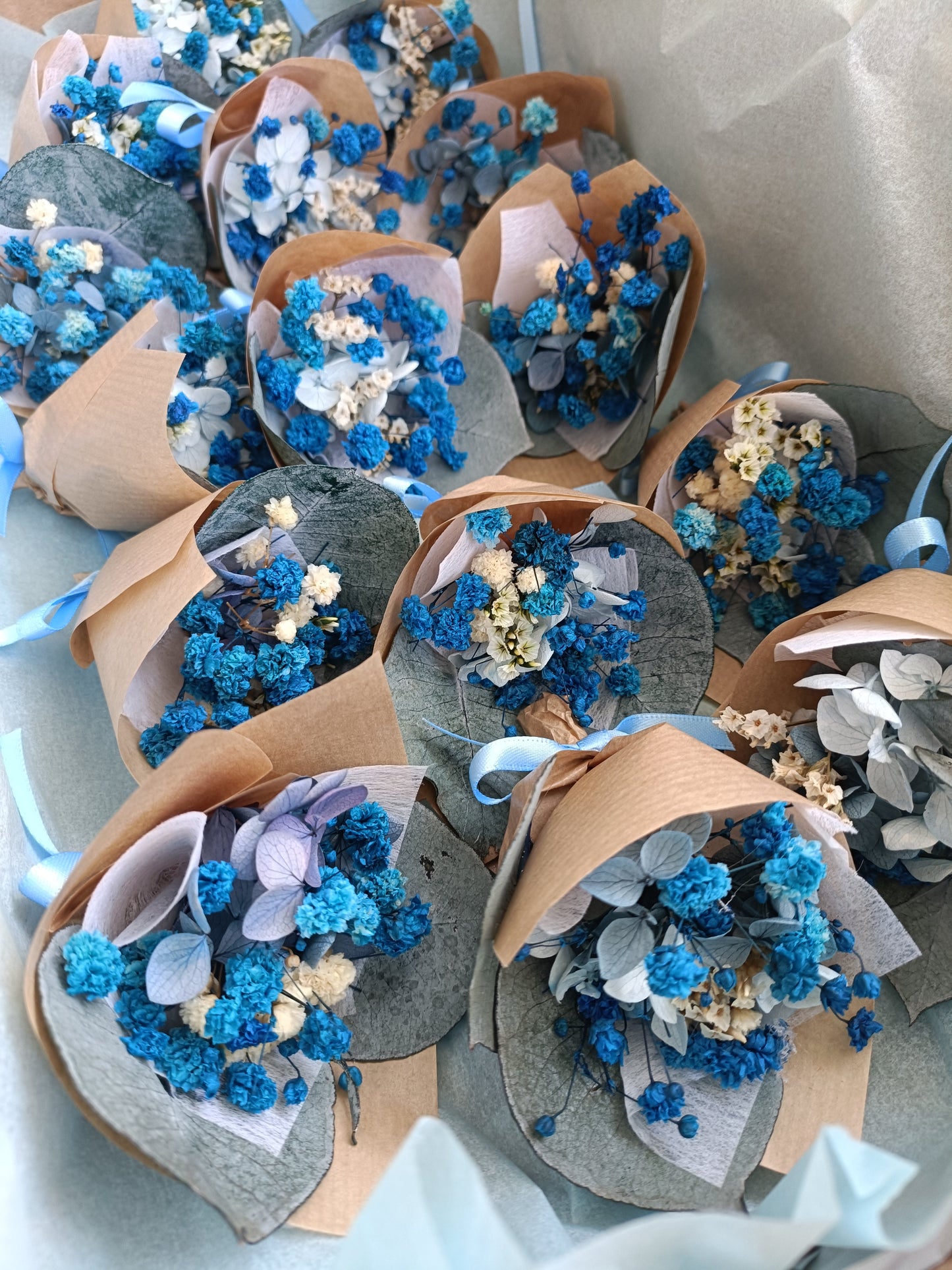 Mini blue and white dried flower bouquets wrapped in kraft paper with ribbon, perfect for weddings, parties, and handmade gifting. Made in Australia.