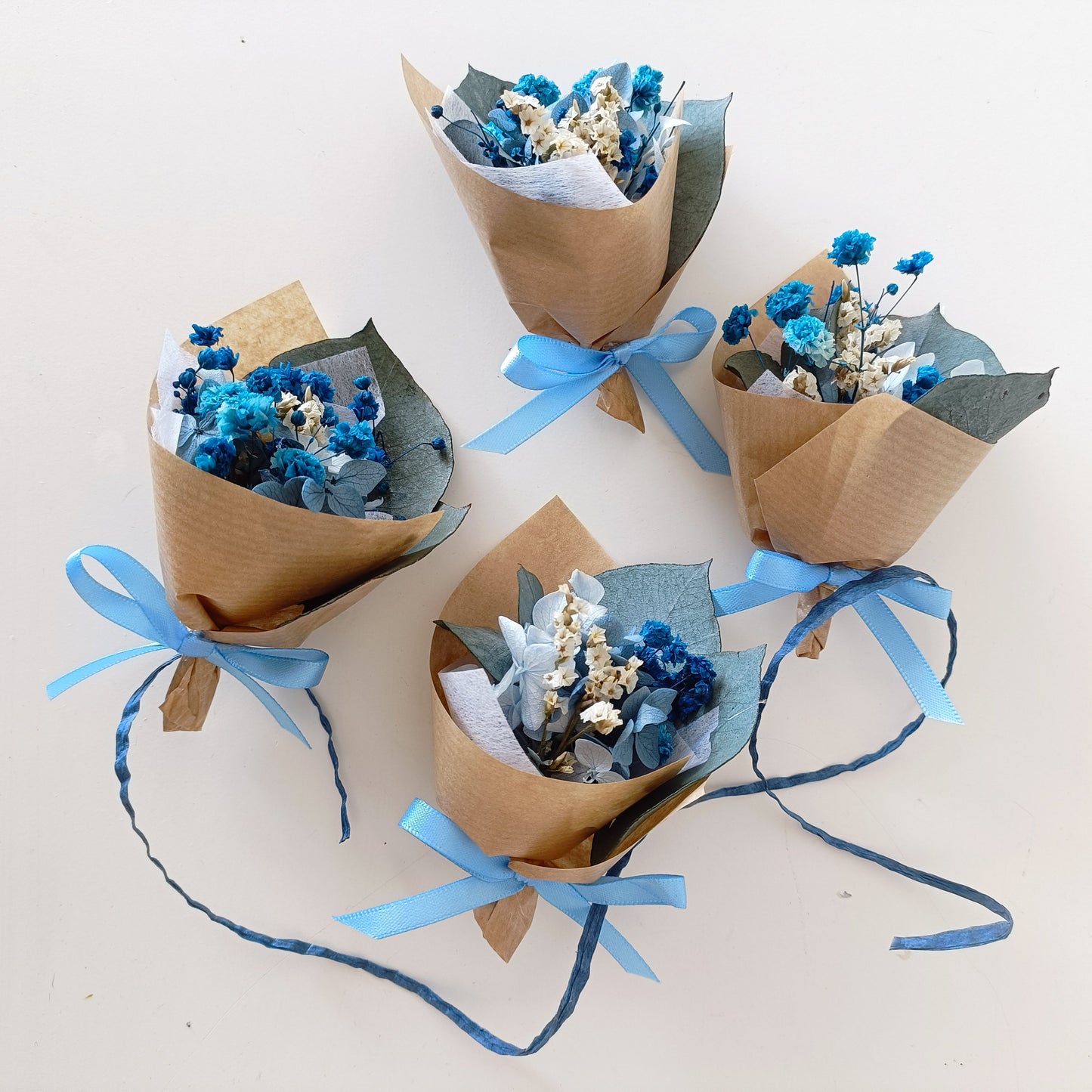 Mini dried flower bouquet in vibrant blue and white tones, wrapped in kraft paper with blue ribbon. Ideal for wedding favours, baby showers, party gifts, or corporate events. Handmade in Australia with shipping to Sydney, Melbourne, Brisbane, Perth, Adelaide and more.