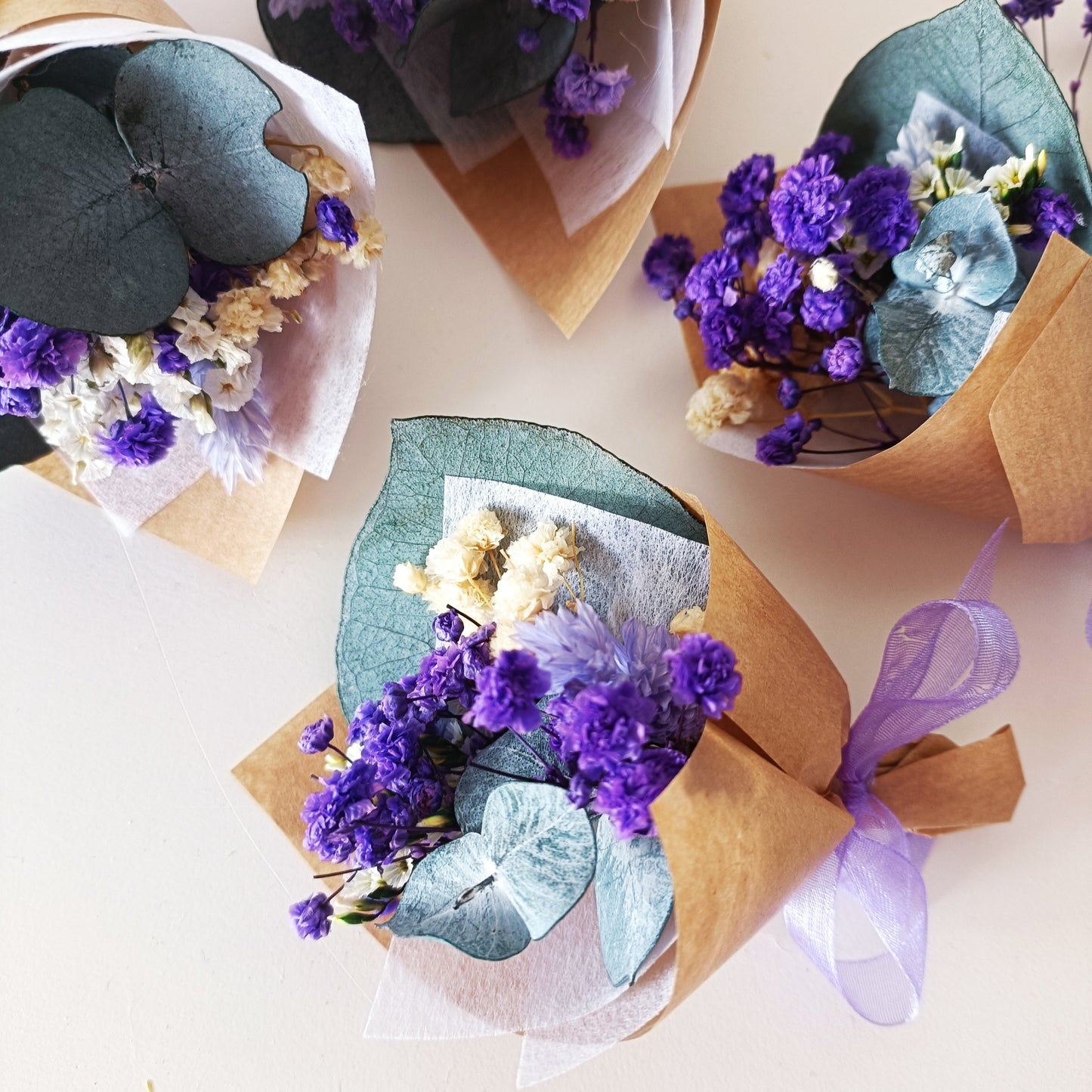 Mini dried flower bouquets in purple and cream, wrapped in kraft paper with ribbon. Perfect for weddings, baby showers, and party favours. Handmade in Australia.