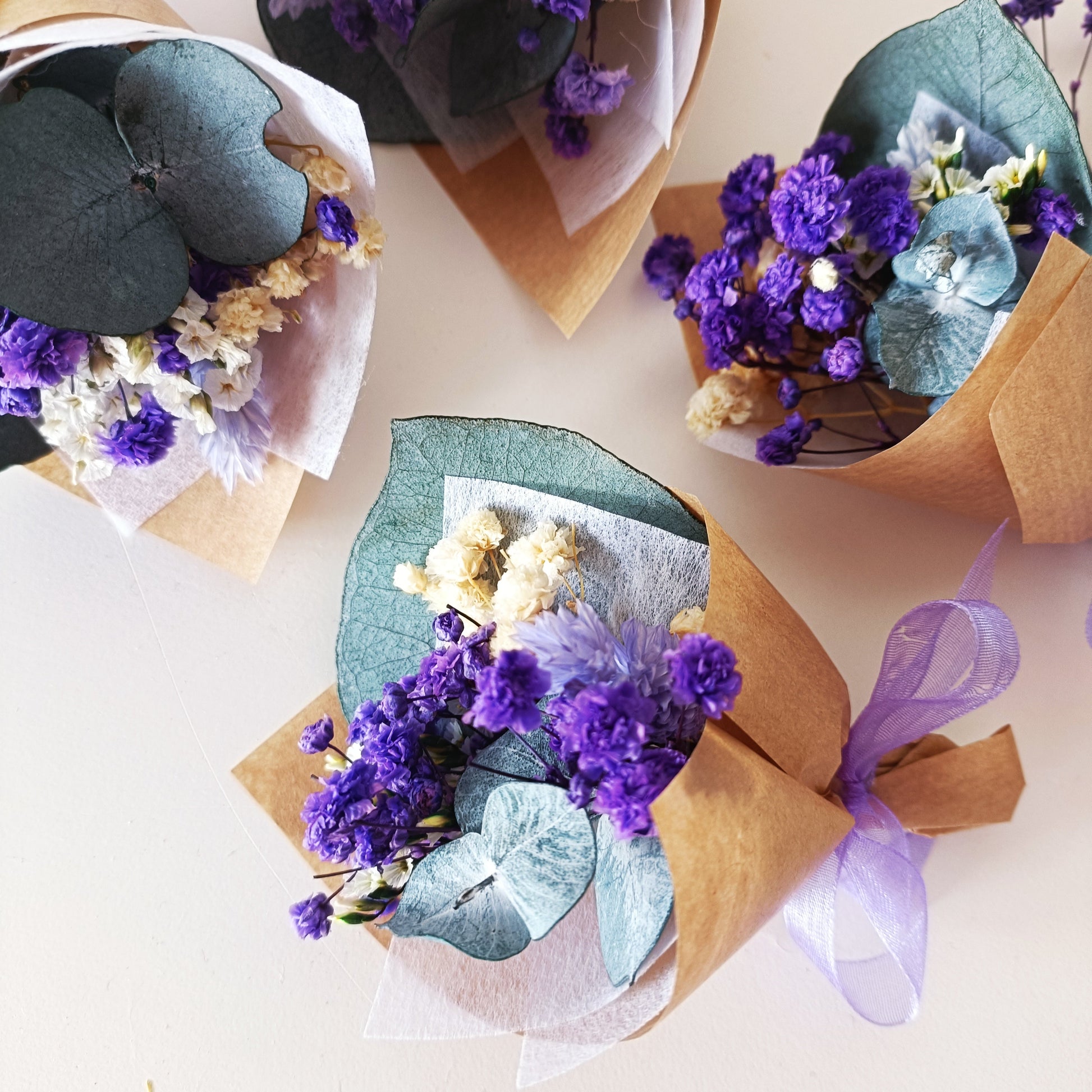 Mini dried flower bouquets in purple and cream, wrapped in kraft paper with ribbon. Perfect for weddings, baby showers, and party favours. Handmade in Australia.