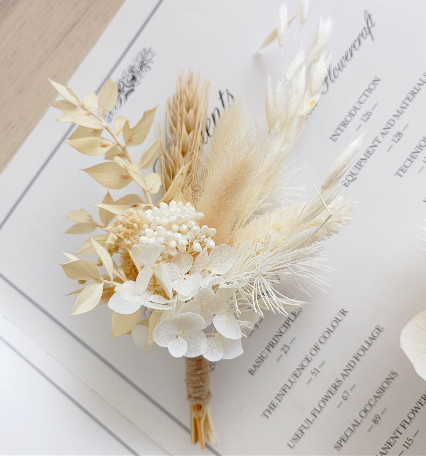 Minimal wedding boutonniere made with sola peonies and dried pampas grass, ideal for modern and elegant bridal looks.