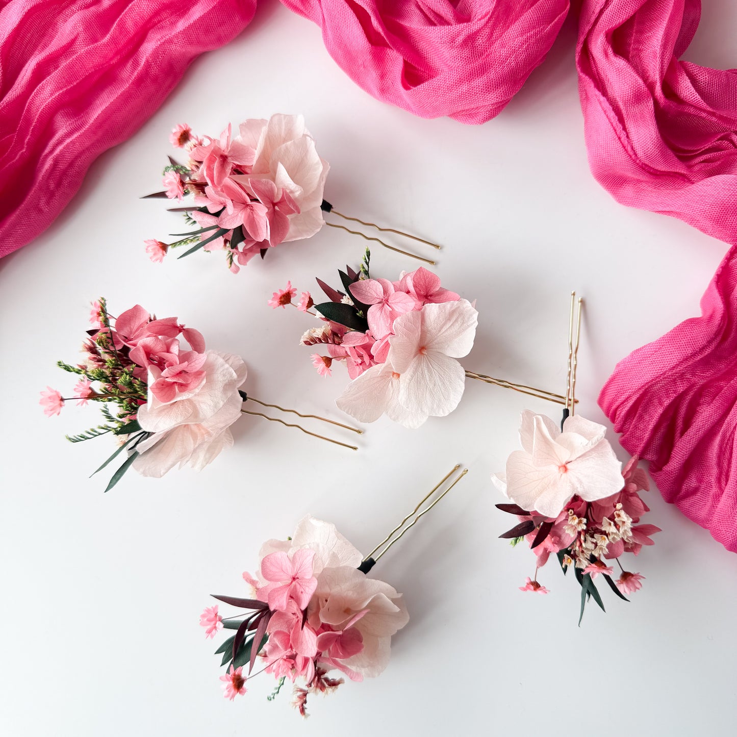 Floral hair pins with pink flowers on a white background