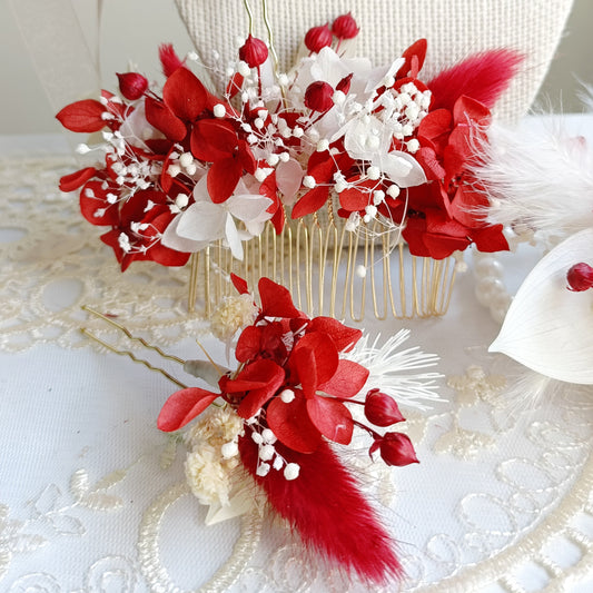 A set of two handcrafted hair clips made from preserved red and white flowers. The clips are detailed with delicate pearl clusters and accented with natural textures for a bohemian feel.