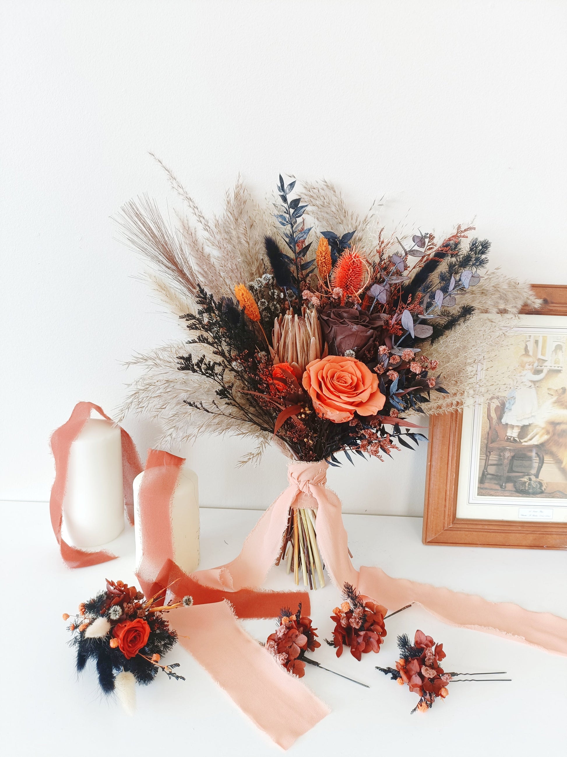 Terracotta bridal bouquet with preserved rose, pampas grass, and dried accents – includes matching boutonniere and floral hair pins for boho weddings.