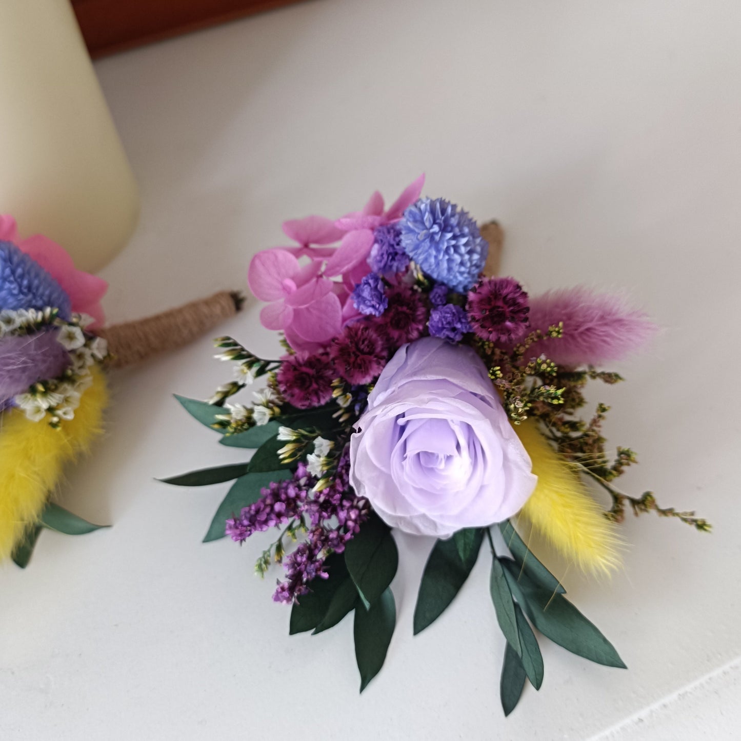 Whimsical dried boutonniere with lavender rose and pastel preserved flowers