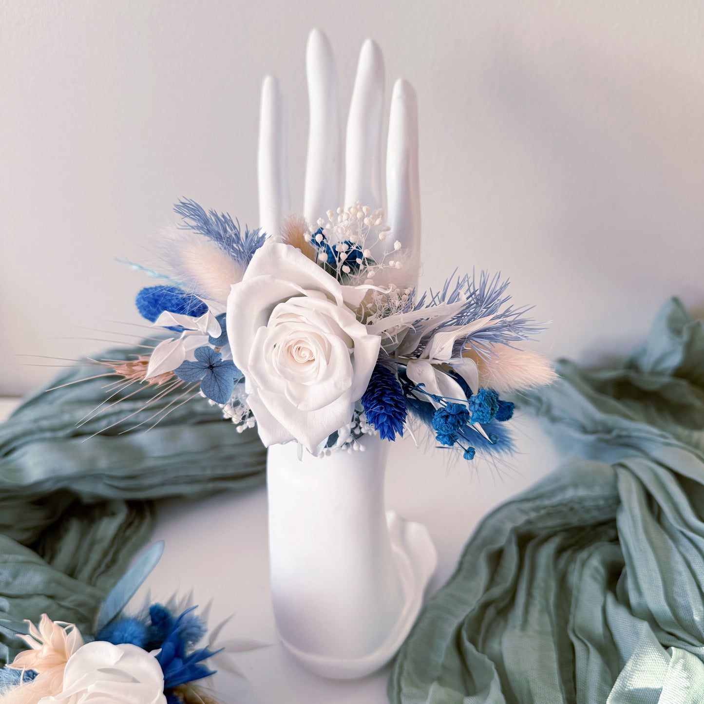 Wrist corsage with white rose in blue