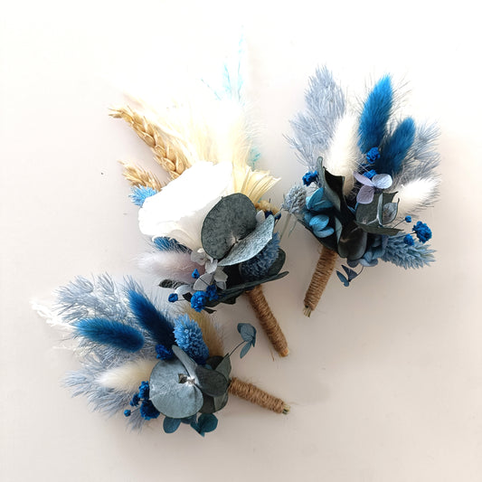 Dusty blue and ivory dried wedding boutonniere set featuring hydrangea, wheat, and twine wrap