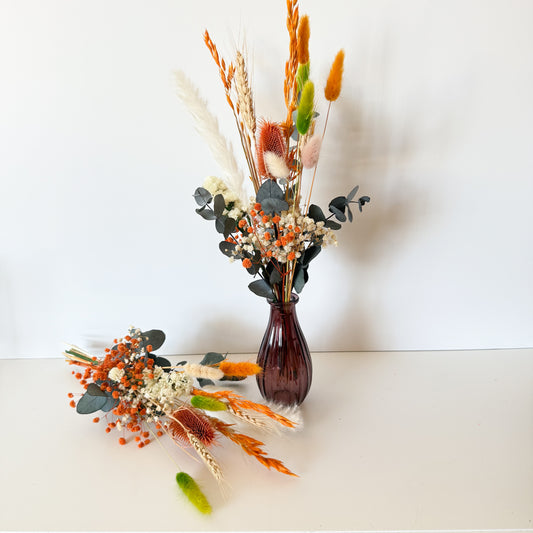 Boho vase decor featuring orange, ivory, and green dried flowers with eucalyptus, perfect for rustic or autumn styling