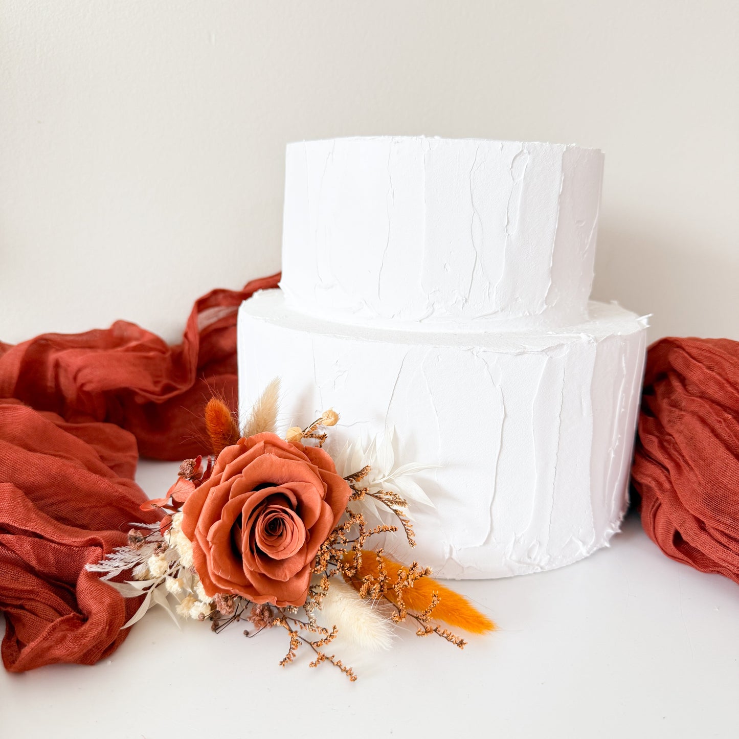 Minimalist white cake with boho burnt orange dried flower topper handmade in Australia
