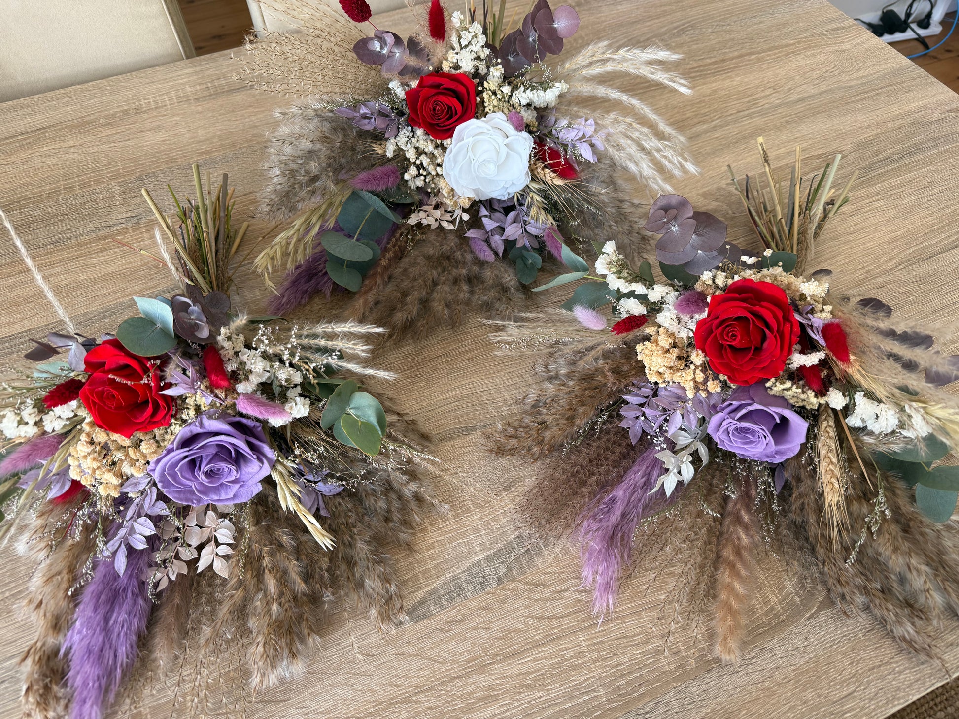 Boho wedding bouquets featuring eucalyptus leaves, white pearl stems, and soft peach preserved flowers