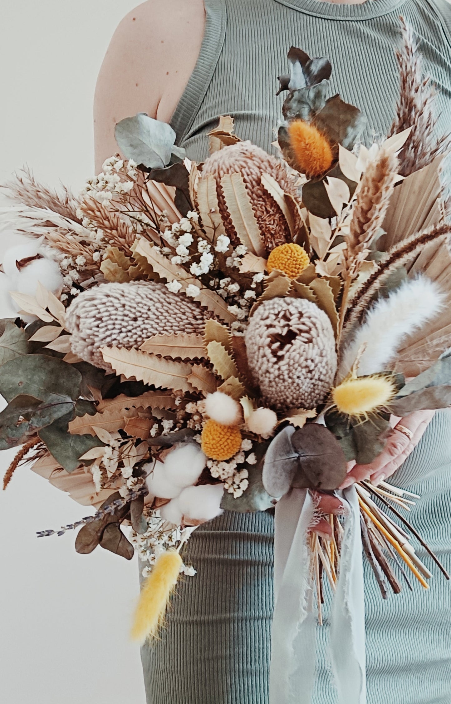 Textured bouquet of preserved flowers including palm leaves, banksia, bunny tails, and cotton – ideal for natural, relaxed wedding styles.