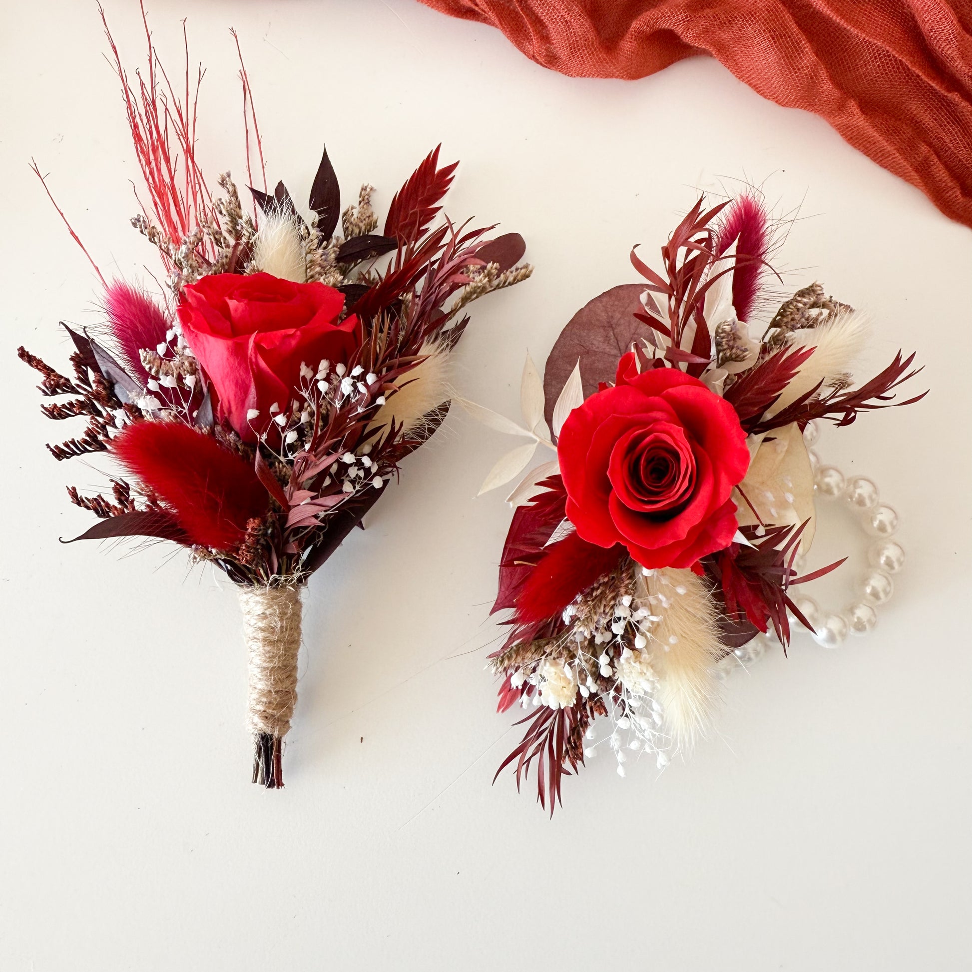 Groom and groomsmen dried flower boutonnieres with burgundy roses, pampas grass, and rustic accents.