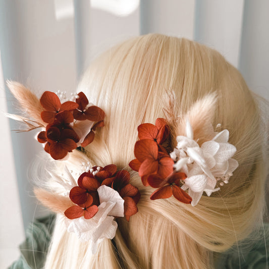 Bridal hair pins with rust and white dried flowers, boho wedding hair accessory on blonde hair.