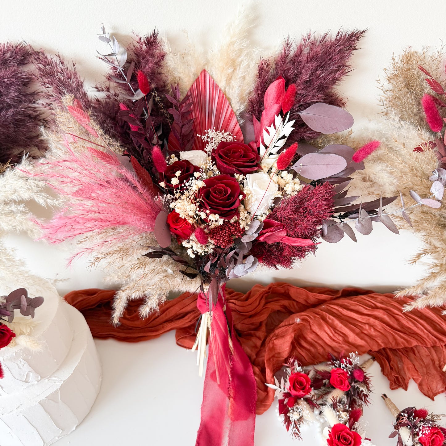 One-sided burgundy and ivory dried flower bridal bouquet with pampas grass, preserved roses, and eucalyptus – boho wedding flowers