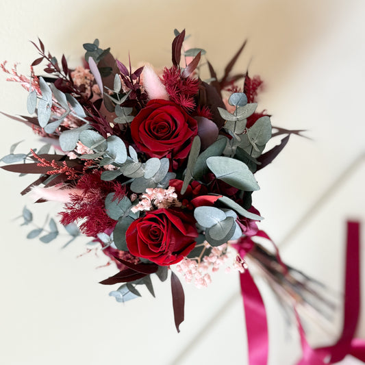 Burgundy dried flower wedding bouquet with preserved roses and eucalyptus