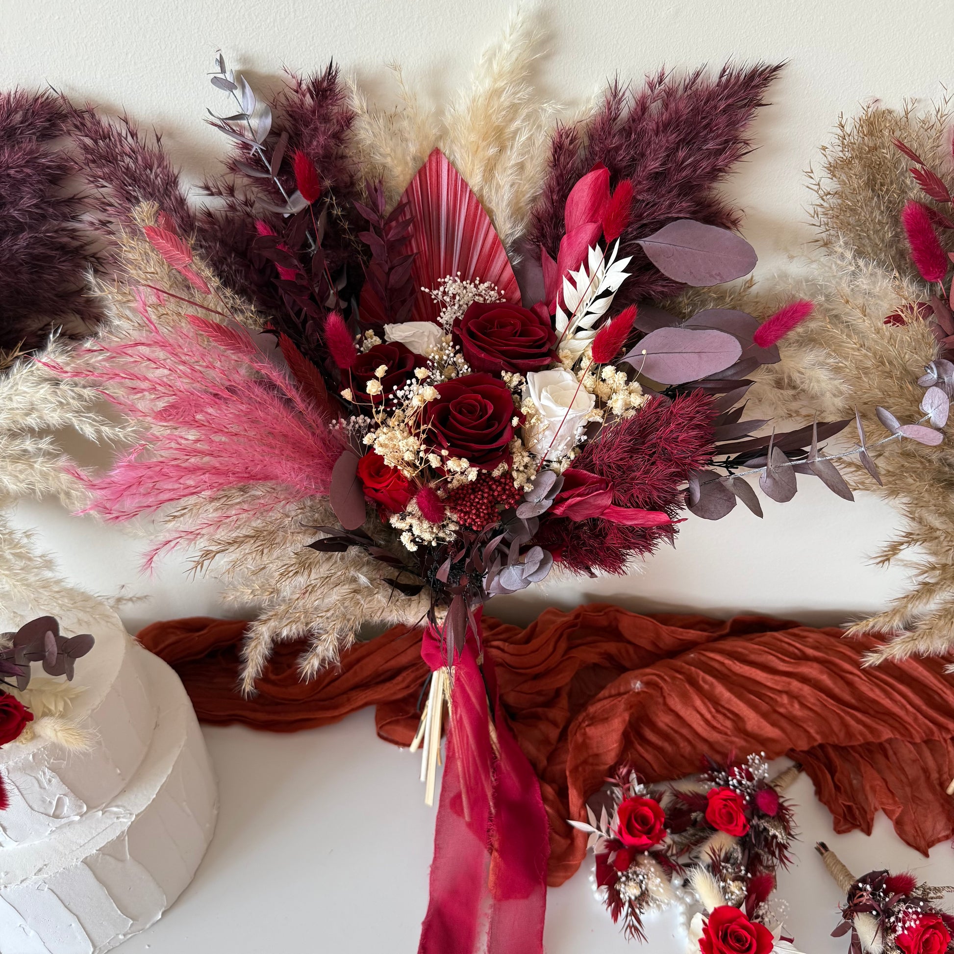 Burgundy and blush dried flower wedding bouquets with pampas grass and preserved roses, styled for Australian brides