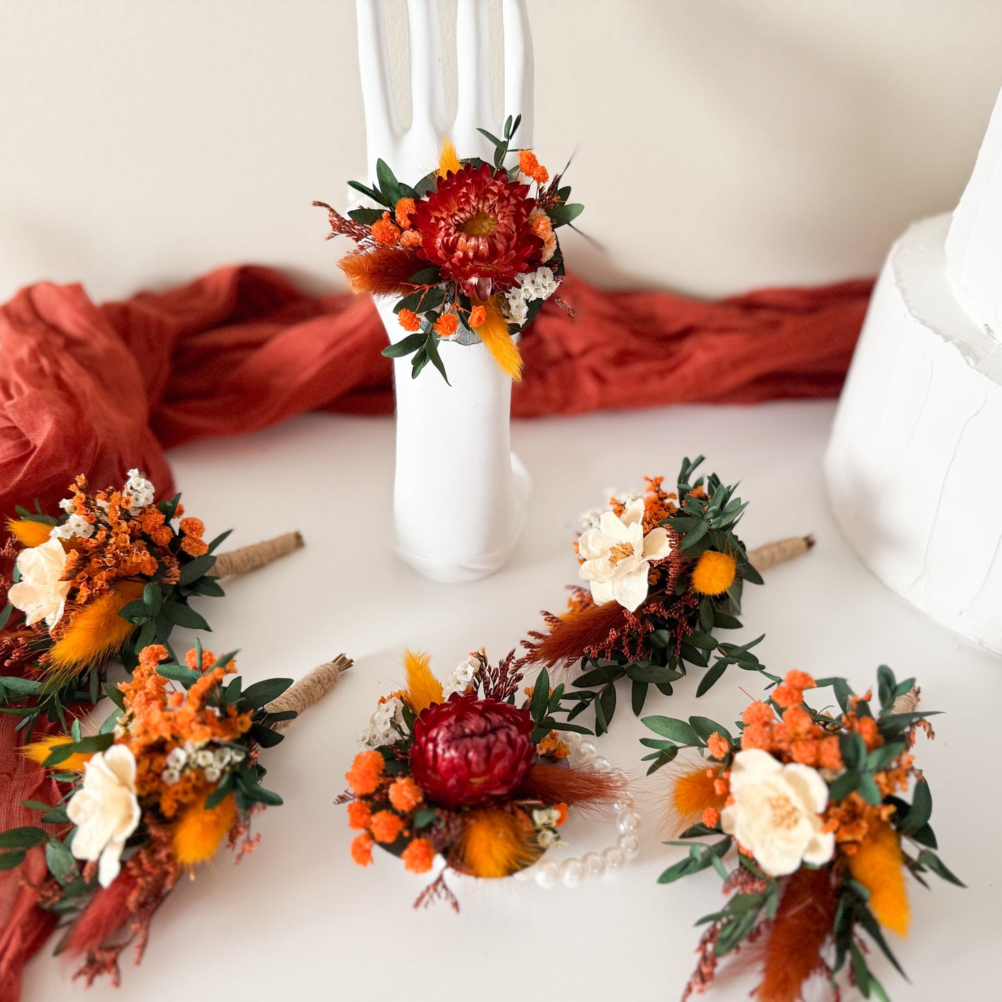 Wedding accessory set with dried flower boutonnieres and bridal hairpins in burnt orange, ivory, and green. Rustic boho handmade floral accents for bride, bridesmaids, groom, and groomsmen. Perfect for rustic, bohemian, or outdoor weddings in Australia