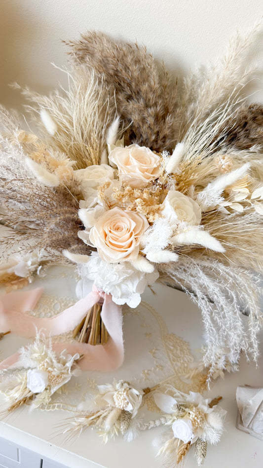 Close-up of dried pampas grass wedding bouquet with ivory roses and preserved florals