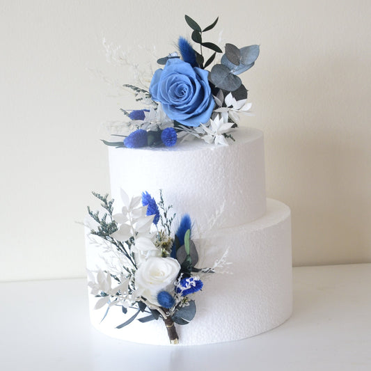 Two-piece dried flower cake topper with blue rose and preserved foliage for modern wedding cakes