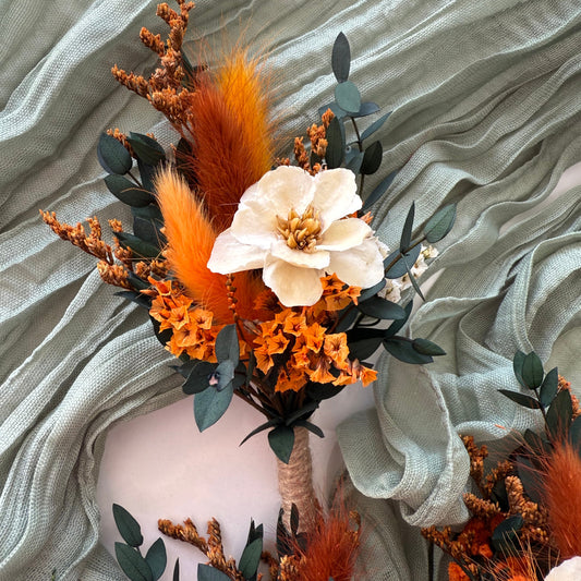 Dried flower boutonnieres with orange and cream florals, rustic boho style groom’s buttonholes