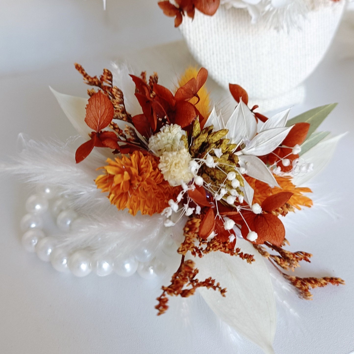 Boho dried flower wrist corsage with burnt orange and ivory preserved flowers on pearl bracelet