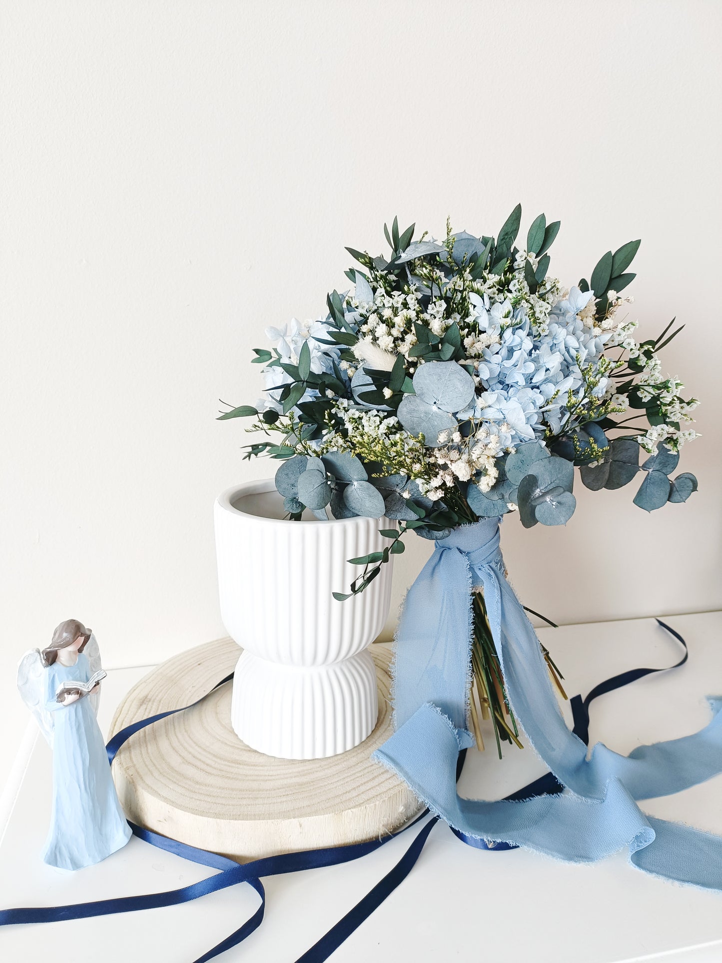 dusty blue wedding bouquet, blue and white bridal bouquet, soft blue floral arrangement, light blue preserved flowers, pastel blue bouquet, rustic blue wedding bouquet, boho blue bridal bouquet, elegant blue and white bouquet, romantic wedding bouquet, vintage-inspired bouquet, medium bridal bouquet, hand-tied wedding bouquet, loose organic bouquet, blue wedding theme, dusty blue wedding inspiration, rustic boho wedding flowers, elegant blue and white wedding, classic blue wedding bouquet