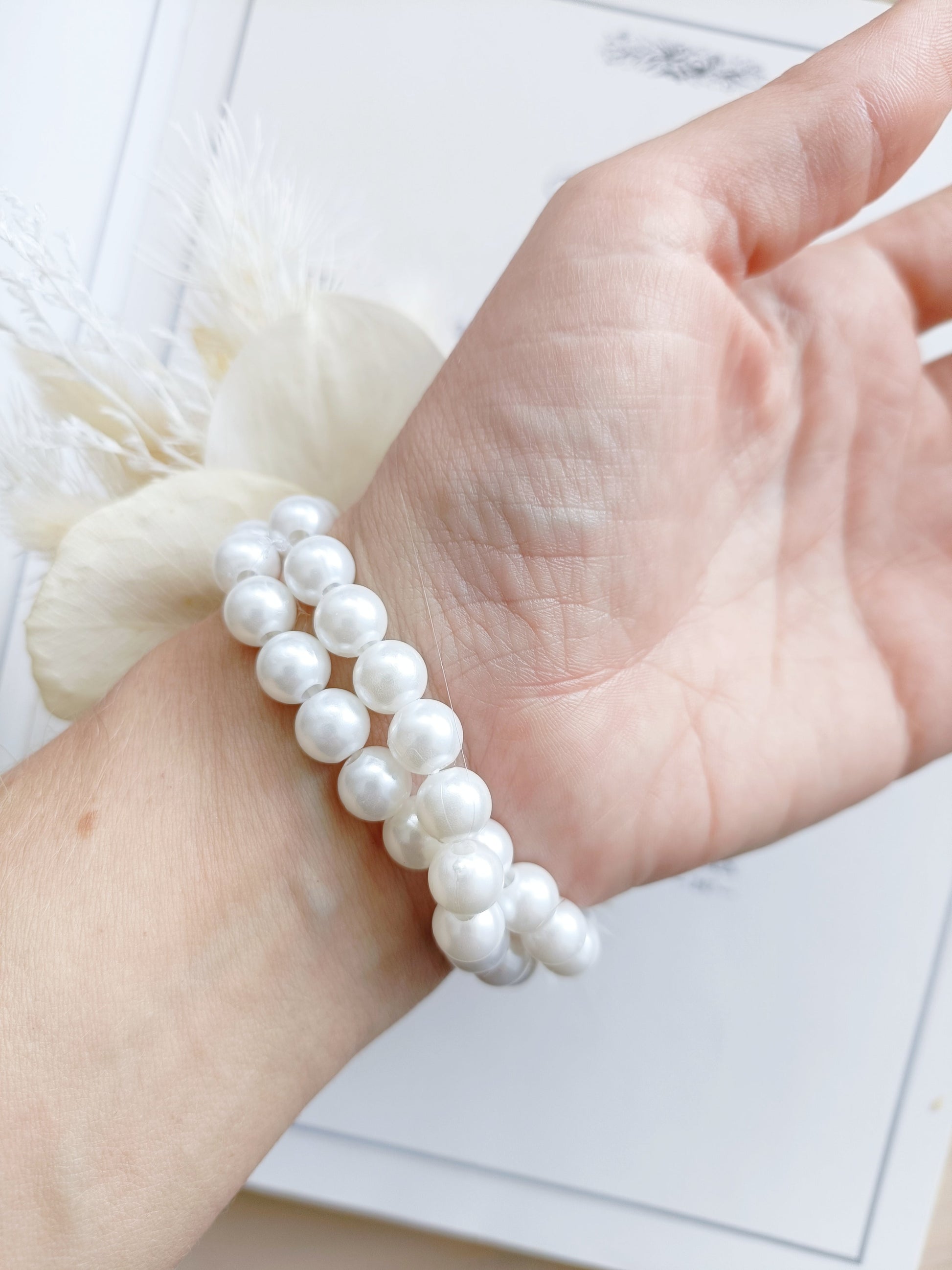 Dried flower wrist corsage with white sola rose, beige bunny tails, preserved grasses, and delicate florals. Handmade neutral dried corsage perfect for bridesmaids, weddings, school formals, or rustic events