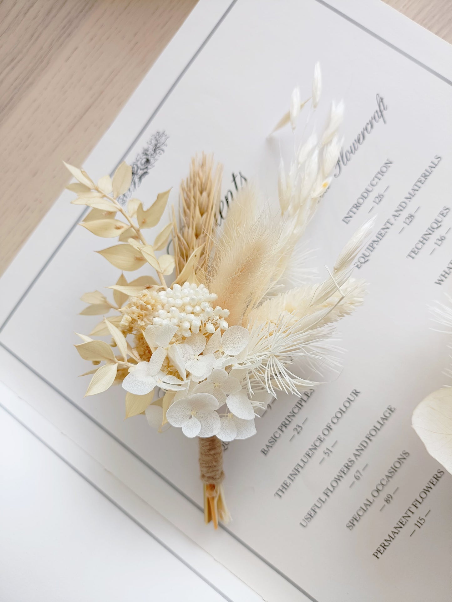 Beige and white dried flower boutonniere with sola wood flowers, bunny tails and preserved leaves – perfect for Australian rustic weddings