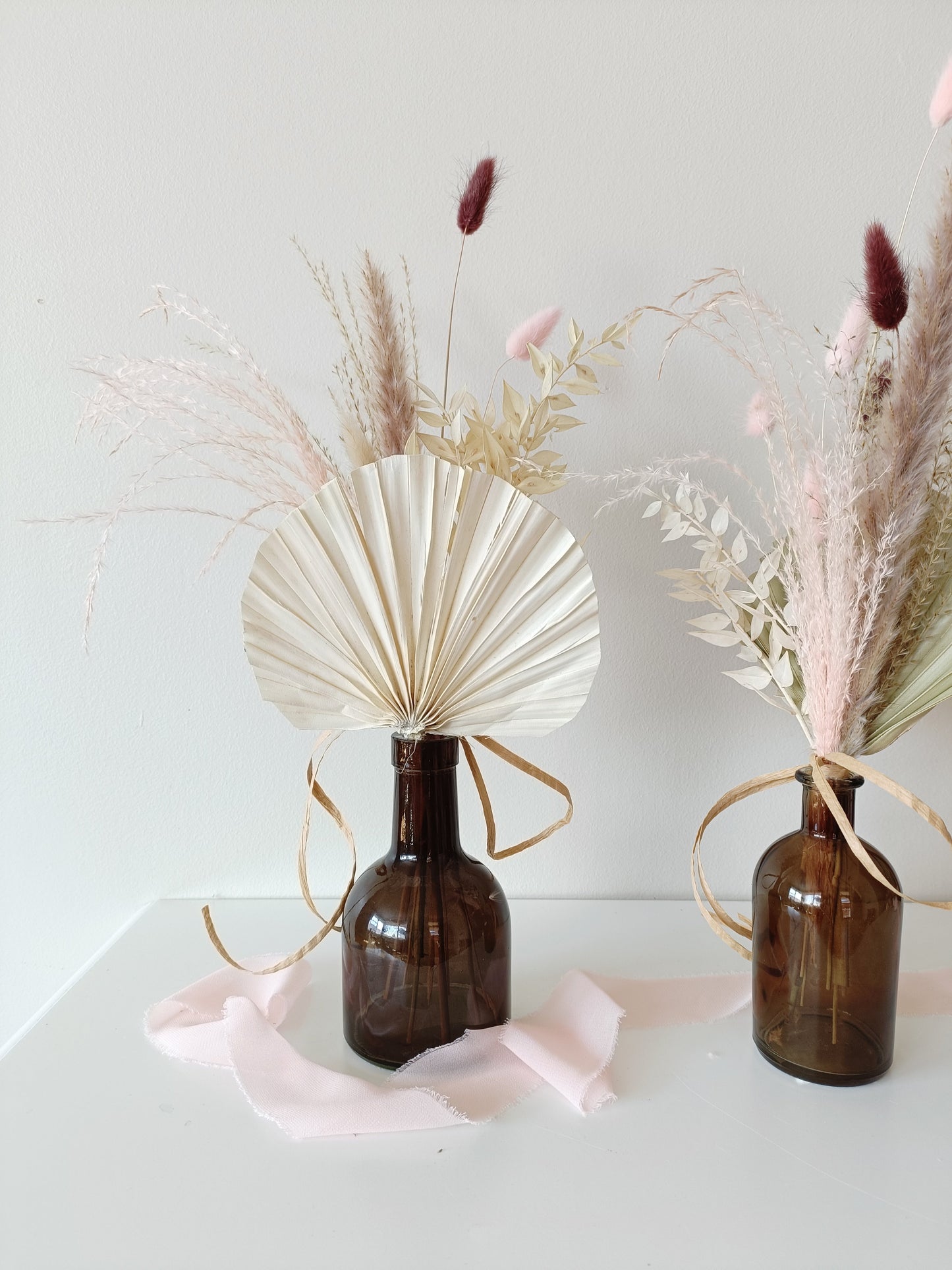 wedding table decor, event table styling, elegant centerpiece, floral arrangement, table setting, rustic wedding, boho table decor, vintage table setup, romantic tablescape, minimalist wedding decor, luxury event design, dried flower centerpiece, soft color palette, aesthetic table arrangement, candlelit dinner, natural wedding decor, modern table styling, cozy reception setup, timeless elegance, pastel wedding theme, chic tablescape, organic table decor, sophisticated floral design, intimate wedding setup