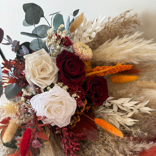 Macro detail of the high-end dried floral arrangement, showcasing the texture of premium preserved roses, dusty miller eucalyptus, and warm rust-coloured accent flowers—ideal for an elegant Australian rustic wedding