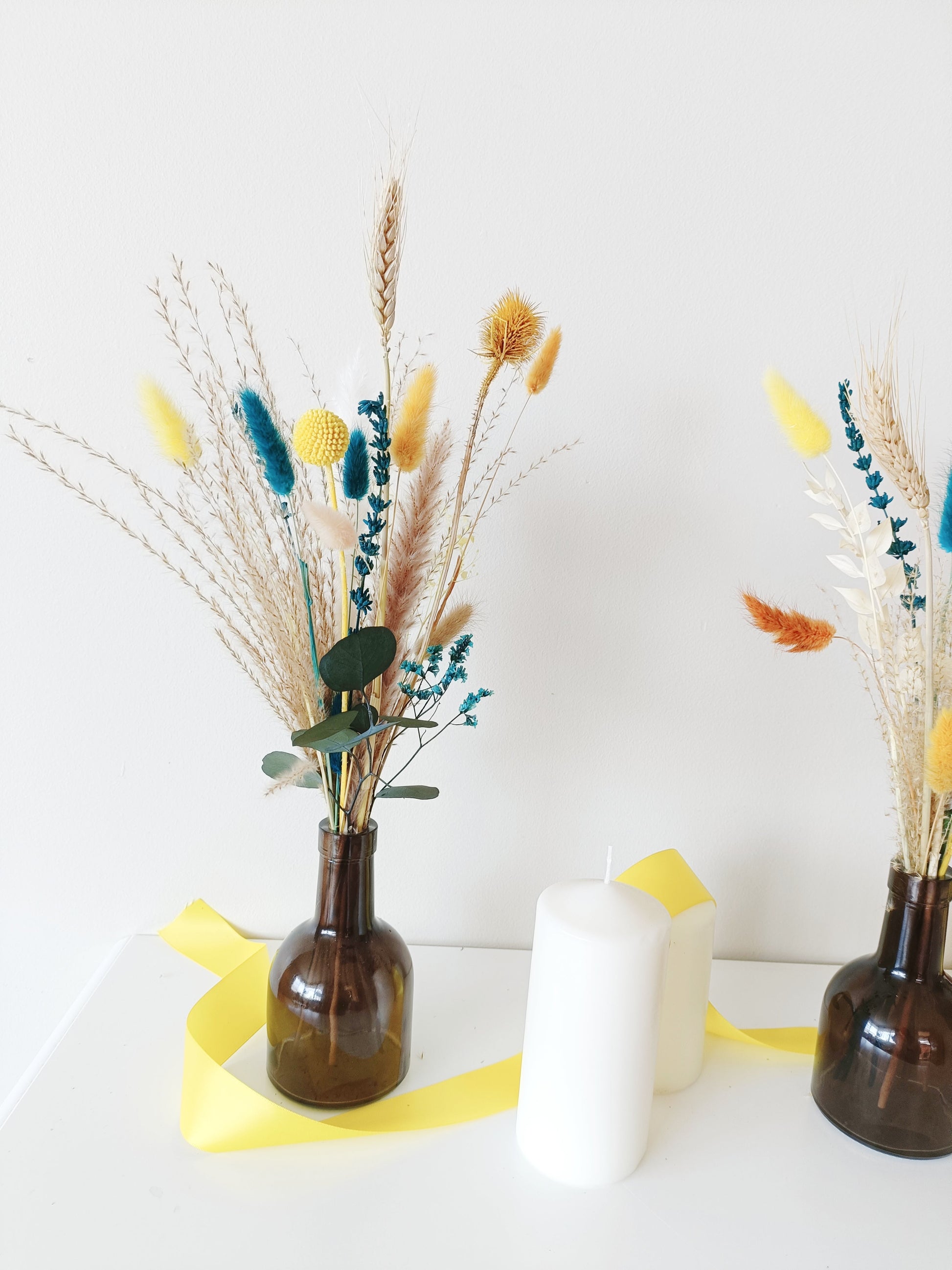 colorful natural centerpiece, terracotta and blue flowers , eye-catching floral vase, handcrafted dried bouquet, unexpected floral styling, creative table florals, intense color dried bouquet, artsy floral centerpiece, autumn wedding flowers, modern bohemian flower decor, unconventional floral styling, trendy wedding floral setup, statement dried flower decor, energetic boho wedding decor, burnt orange wedding bouquet, bold color flower styling, dynamic floral table decor, festive floral arrangement