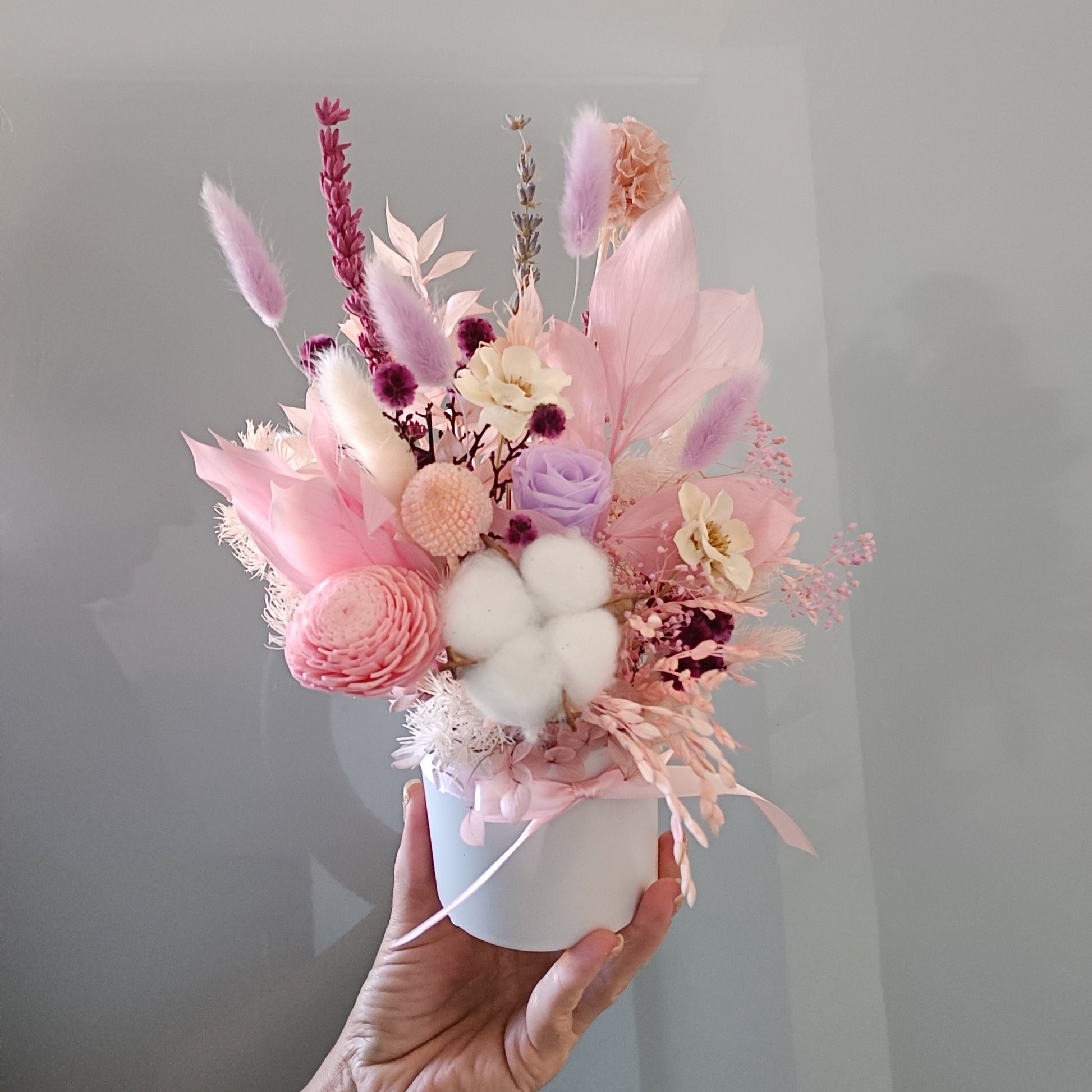 Whimsical pastel dried flower bouquet with soft textures and romantic tones, perfect for gifting to a friend or brightening up a cozy room.