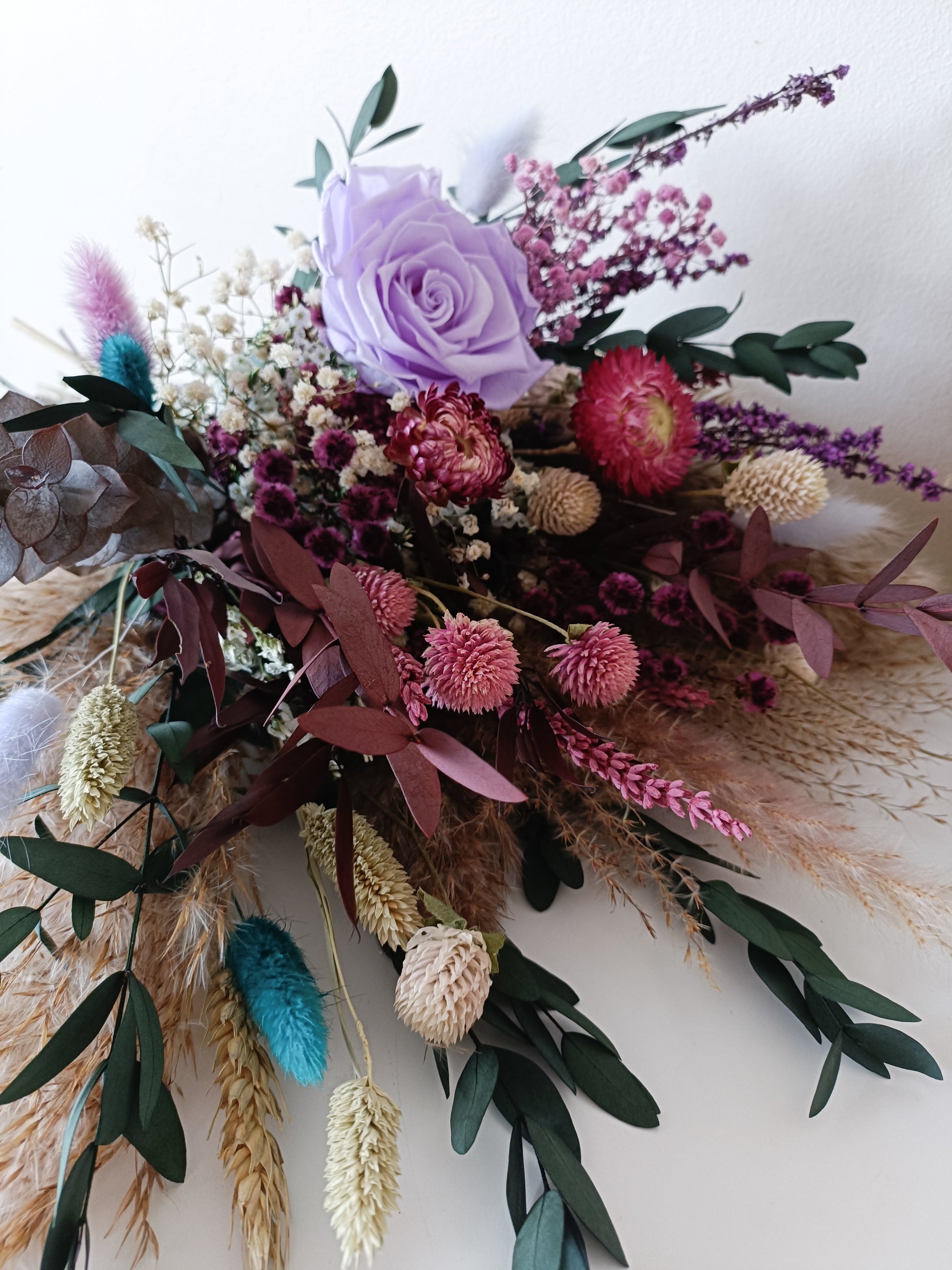 Dried flower bridal bouquet with lilac sola rose, strawflower, pampas grass, and preserved greenery – perfect for rustic or boho weddings