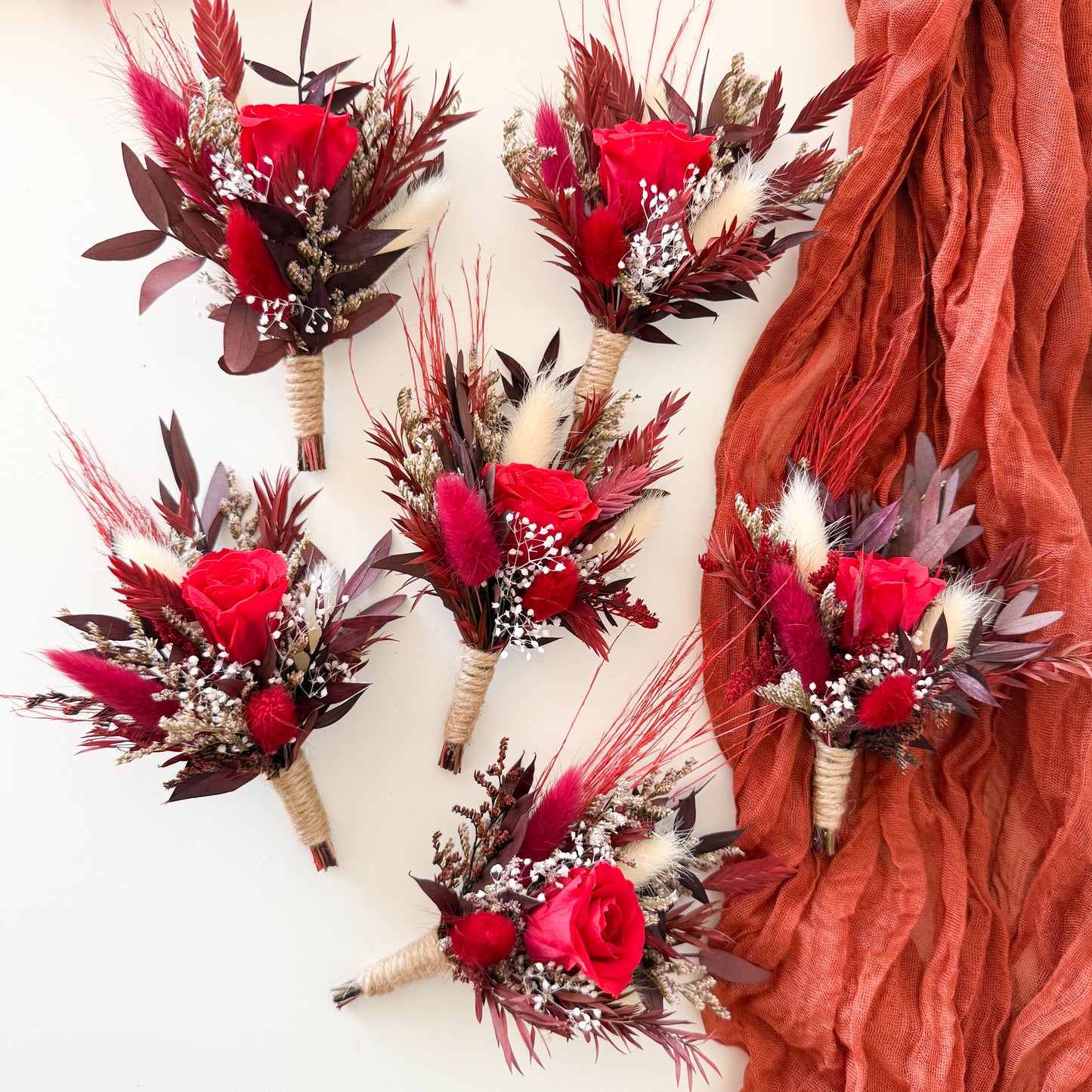 Set of dried flower boutonnieres with red sola wood roses, burgundy foliage, rustic twine wrap and boho accents, handmade groomsmen accessories for weddings, rustic style boutonniere set.