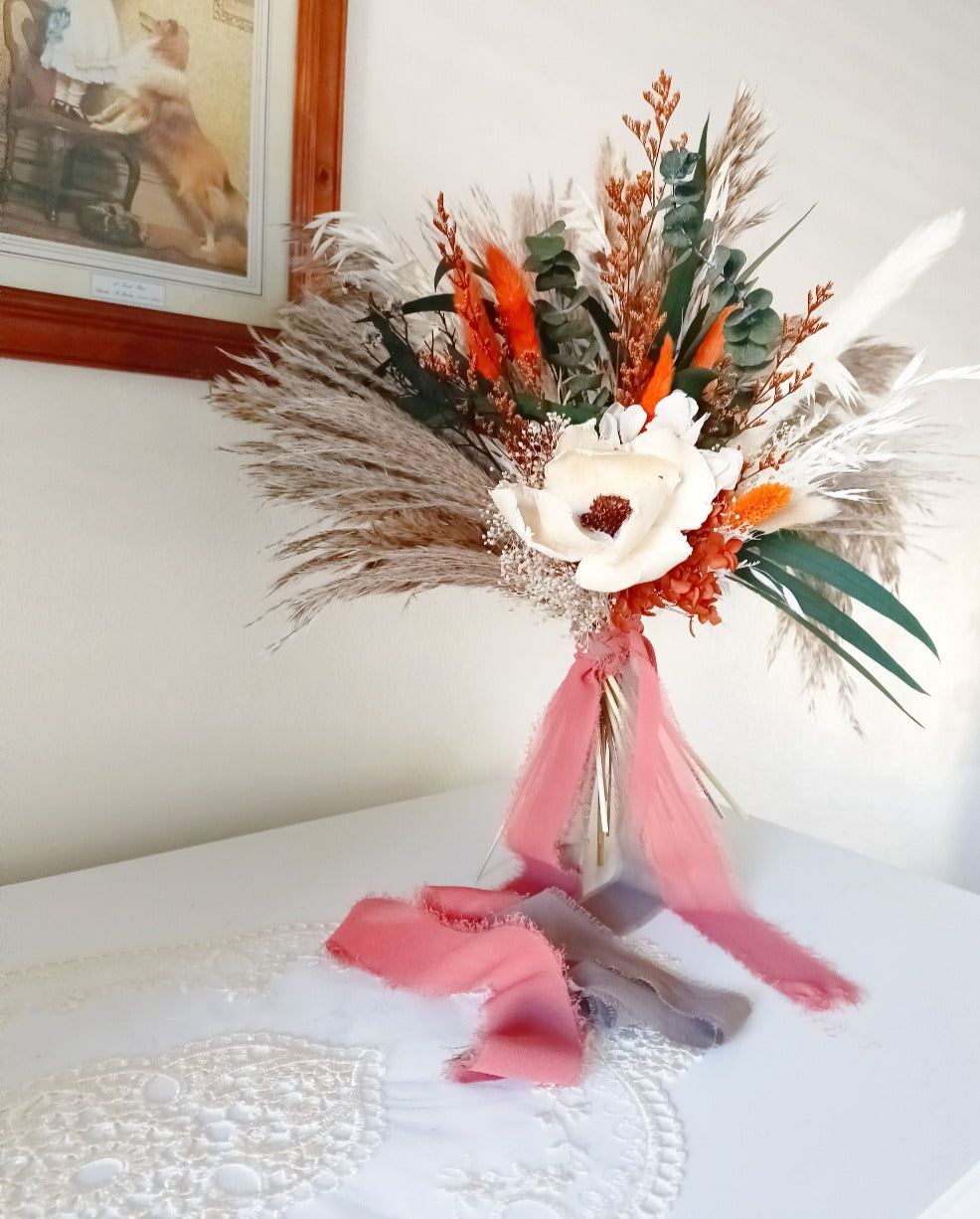 Rustic dried flower bouquet with preserved foliage, natural wheat, and orange strawflowers, styled for weddings and home decor in Australia.