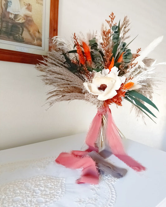 Rustic dried flower bouquet with preserved foliage, natural wheat, and orange strawflowers, styled for weddings and home decor in Australia.