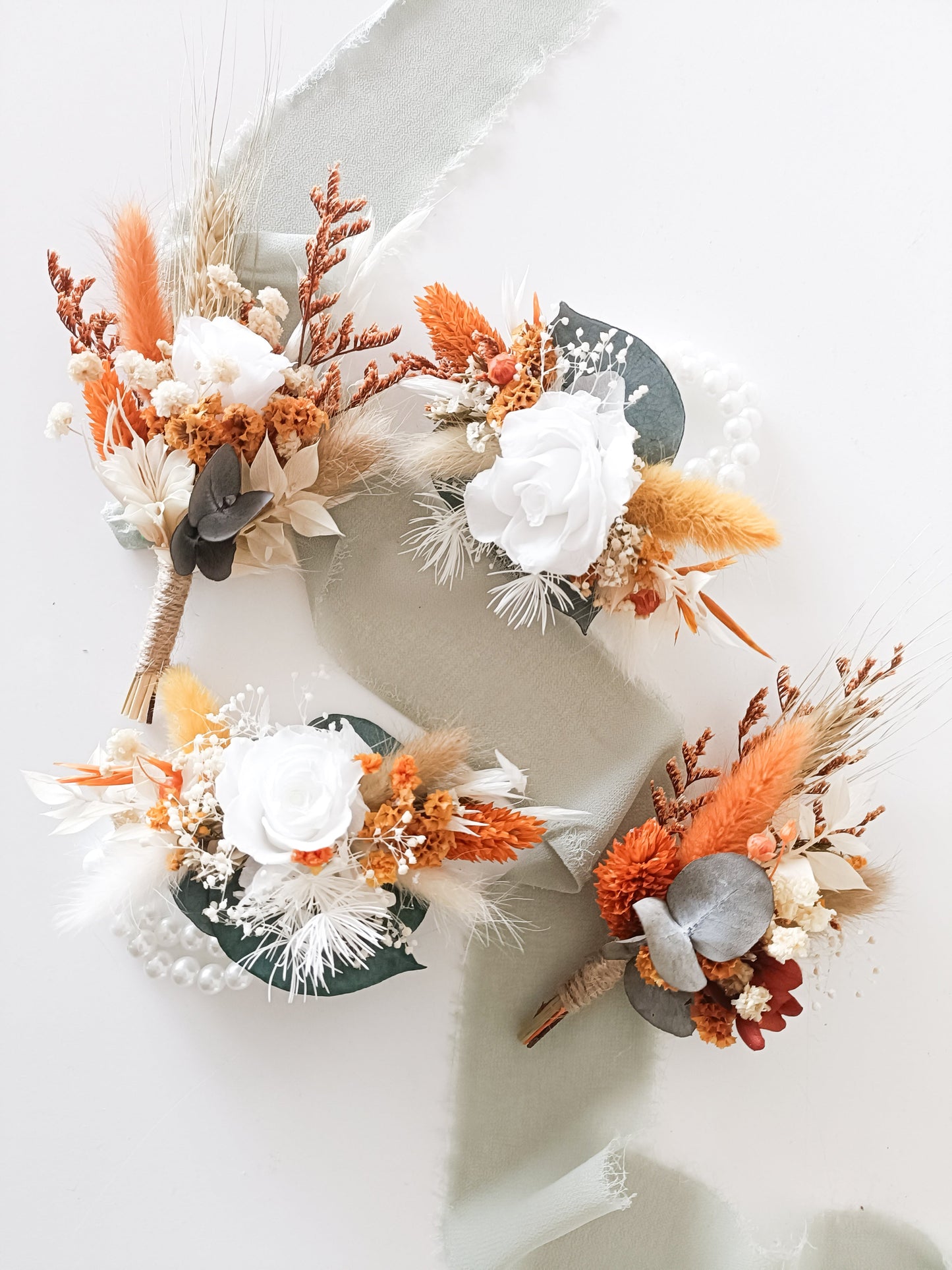 Mini bouquet or boutonniere and wrist corsage made with preserved bunny tails, strawflowers, eucalyptus and orange accents — perfect match to bridal bouquet