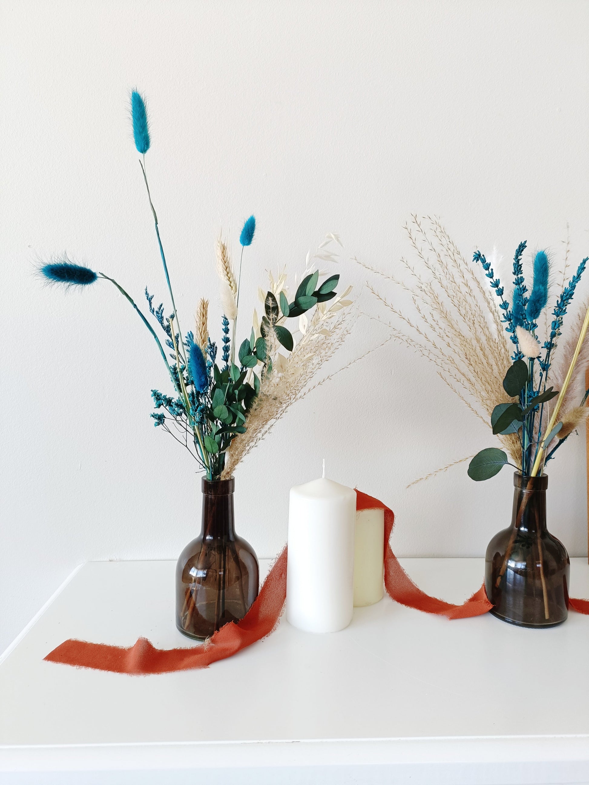 country-style flower decor, soft pink flower setup, classic boho wedding flowers, vintage-inspired floral decor, delicate flower arrangement, stylish dried flower vase, timeless dried flowers, elegant table styling, wedding reception florals, beige flower display, soft aesthetic floral decor, dried palm leaf bouquet, artistic dried flowers, trendy boho arrangement, unique floral table setting, charming wedding centerpiece, aesthetic bohemian wedding, pampas grass styling, dreamy floral arrangement