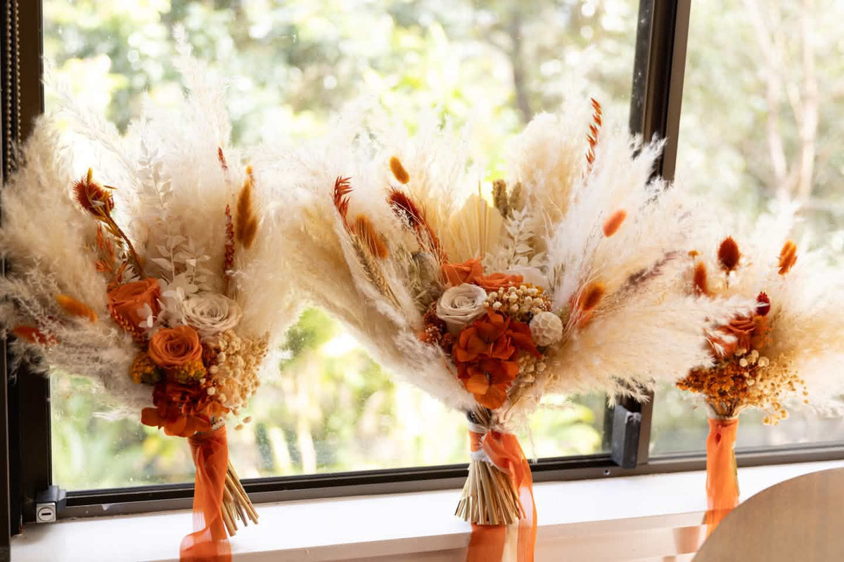 Terracotta and burnt orange dried wedding bouquets with ivory pampas grass, preserved roses and hydrangea